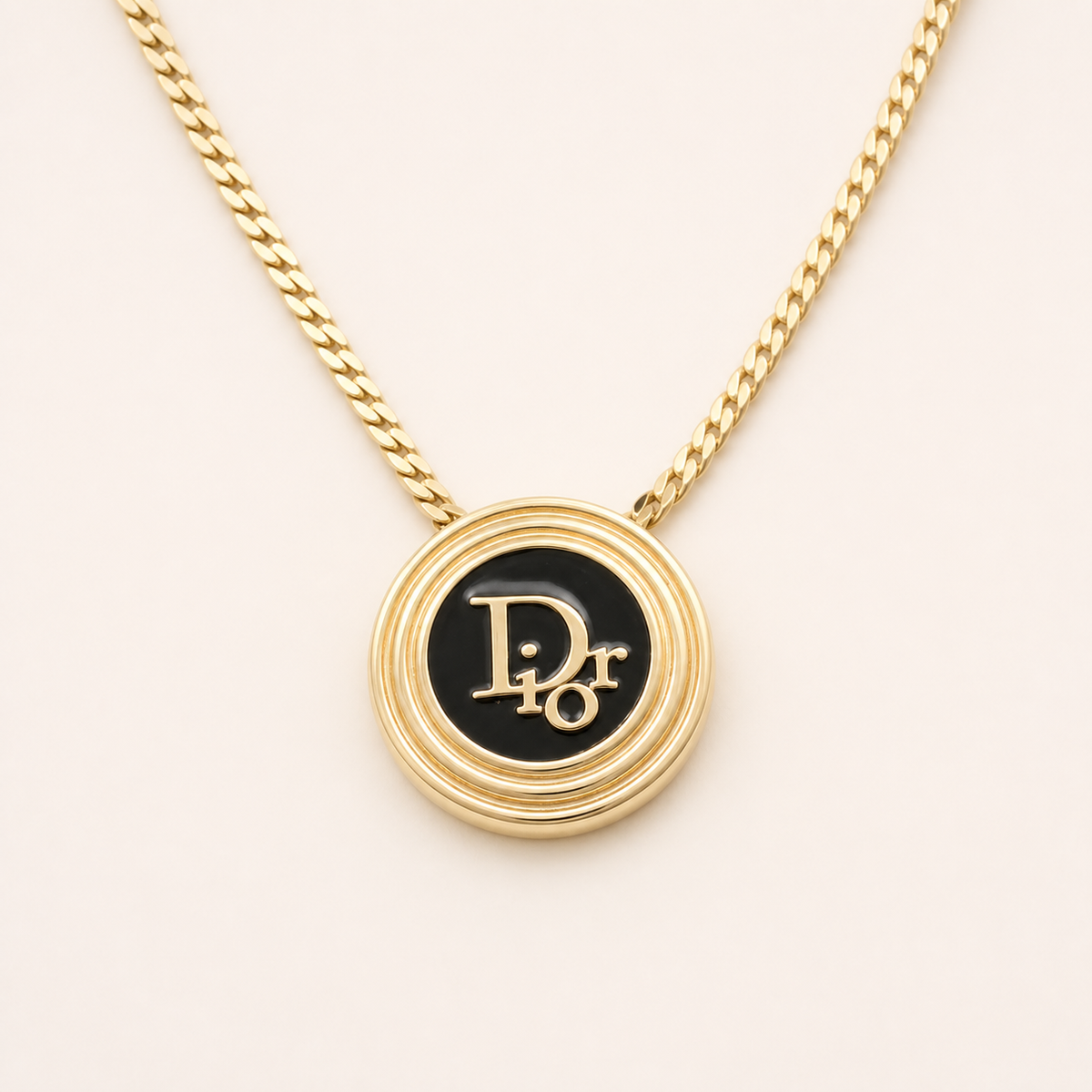 Christian Dior black logo medallion necklace in gold-tone metal