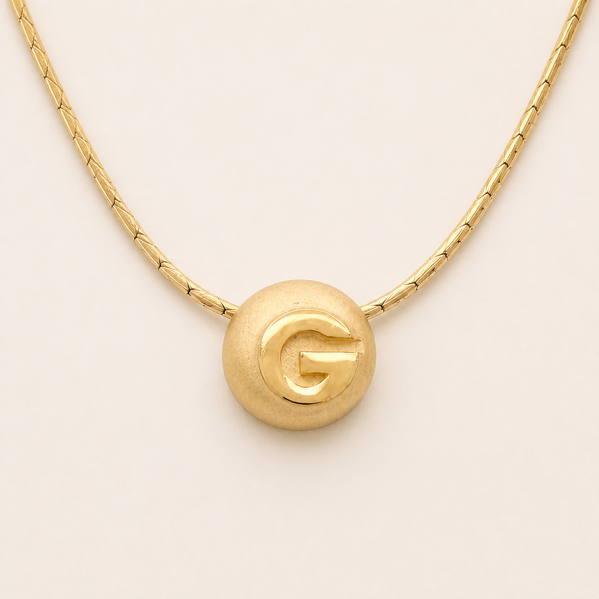 Givenchy G dome pendant necklace in satin gold-tone metal
