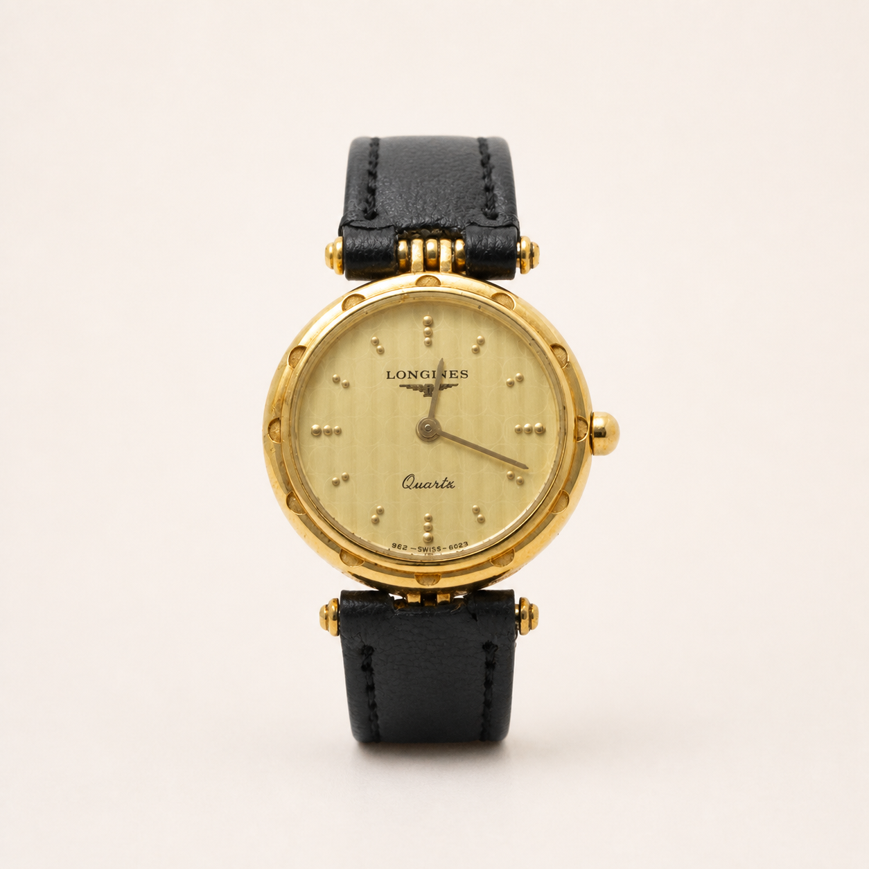 Vintage Longines gold-tone round quartz watch with black leather strap