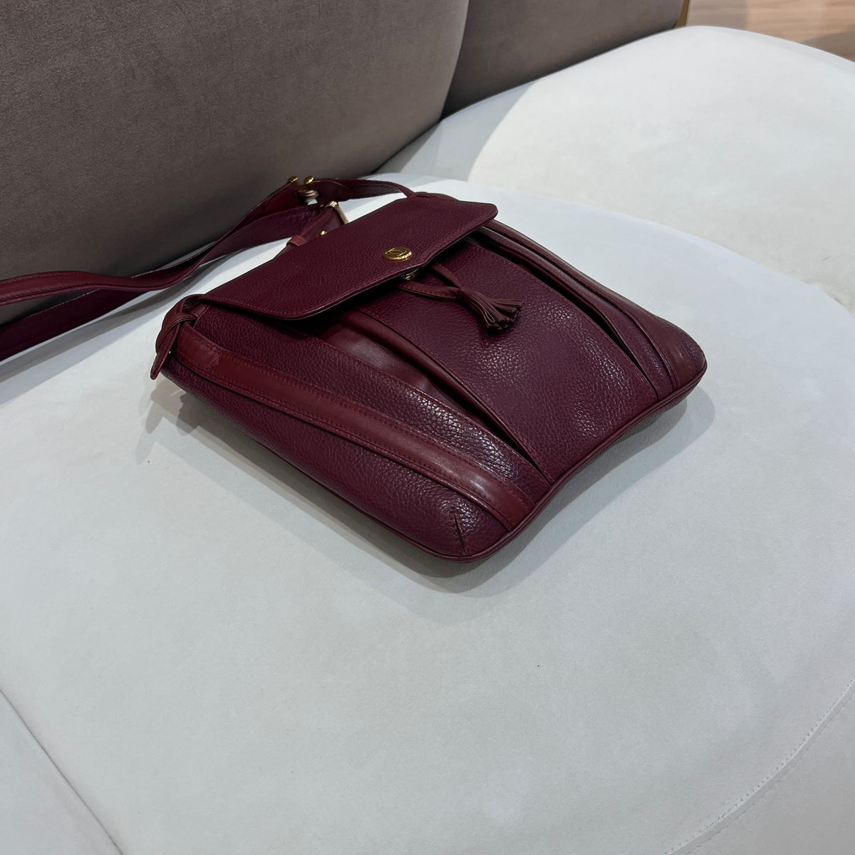 Cartier Burgundy Flap Backpack with Tassel Detail — base corner
