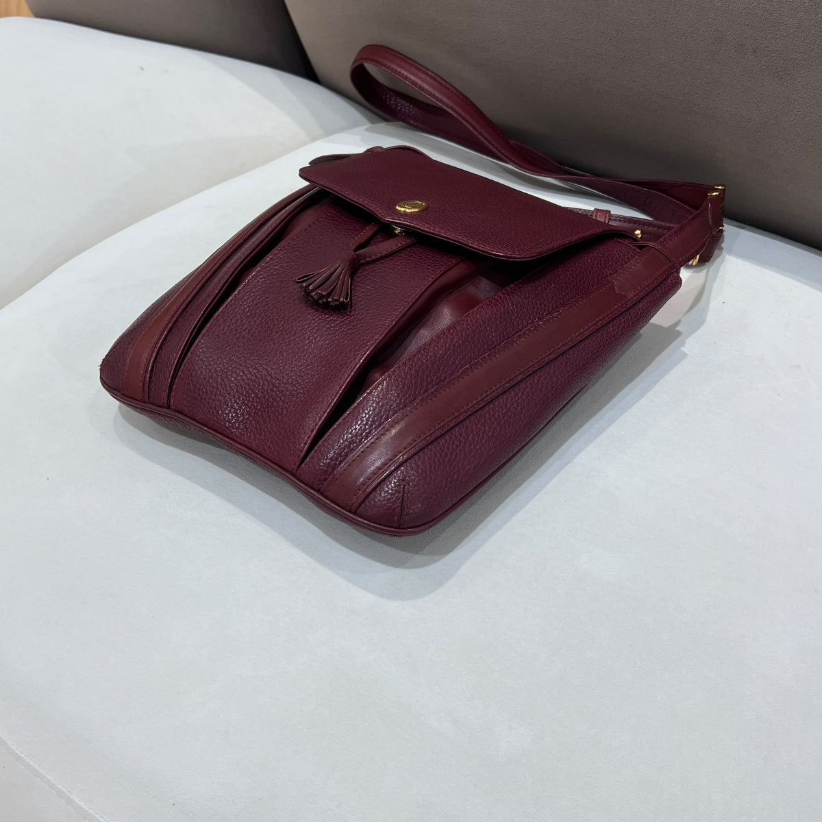 Cartier Burgundy Flap Backpack with Tassel Detail — opposite base corner