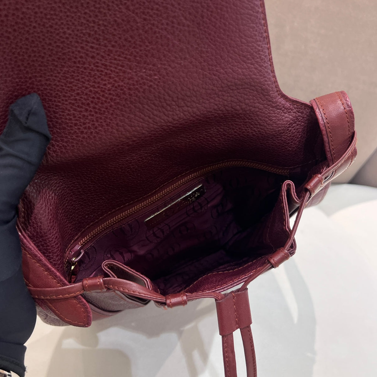 Cartier Burgundy Flap Backpack with Tassel Detail — open interior