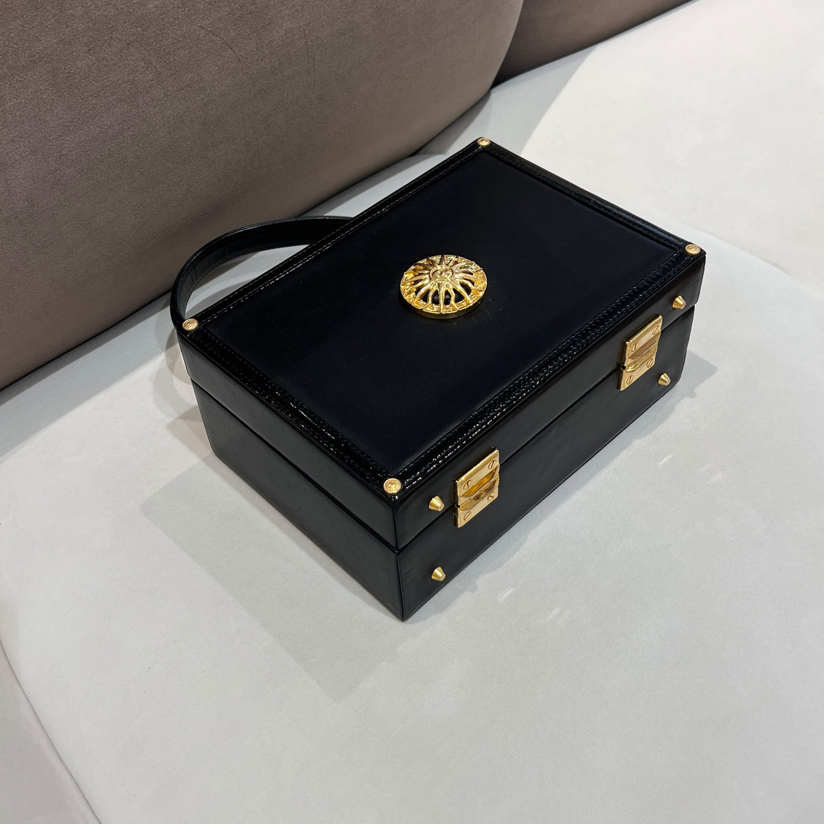 Versace Black Vanity Box Handbag with Gold-Tone Sunburst — base corner