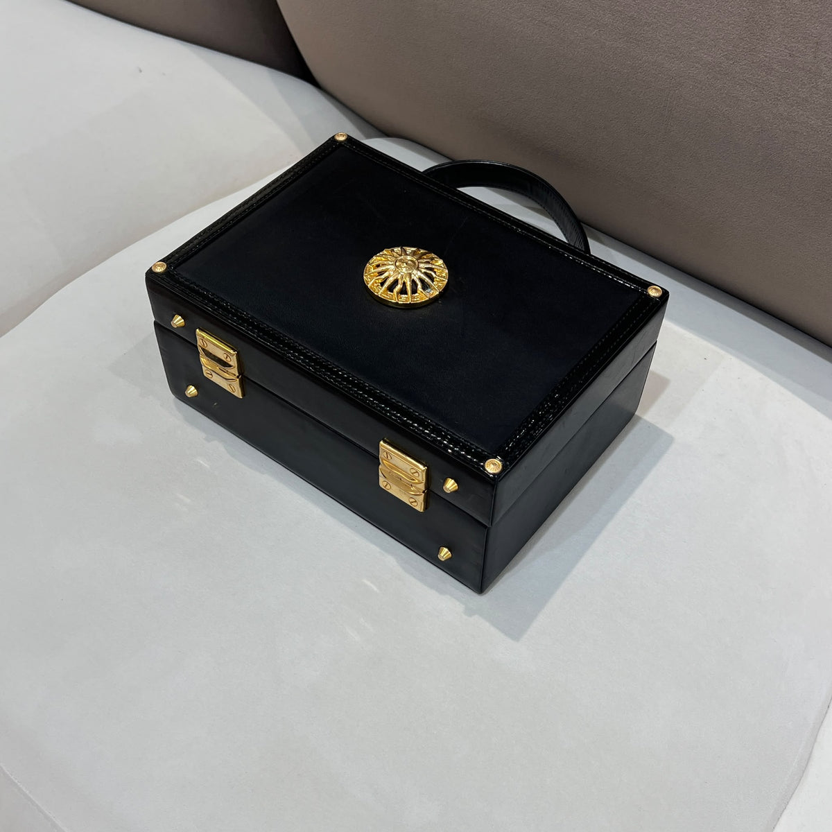 Versace Black Vanity Box Handbag with Gold-Tone Sunburst — opposite base corner