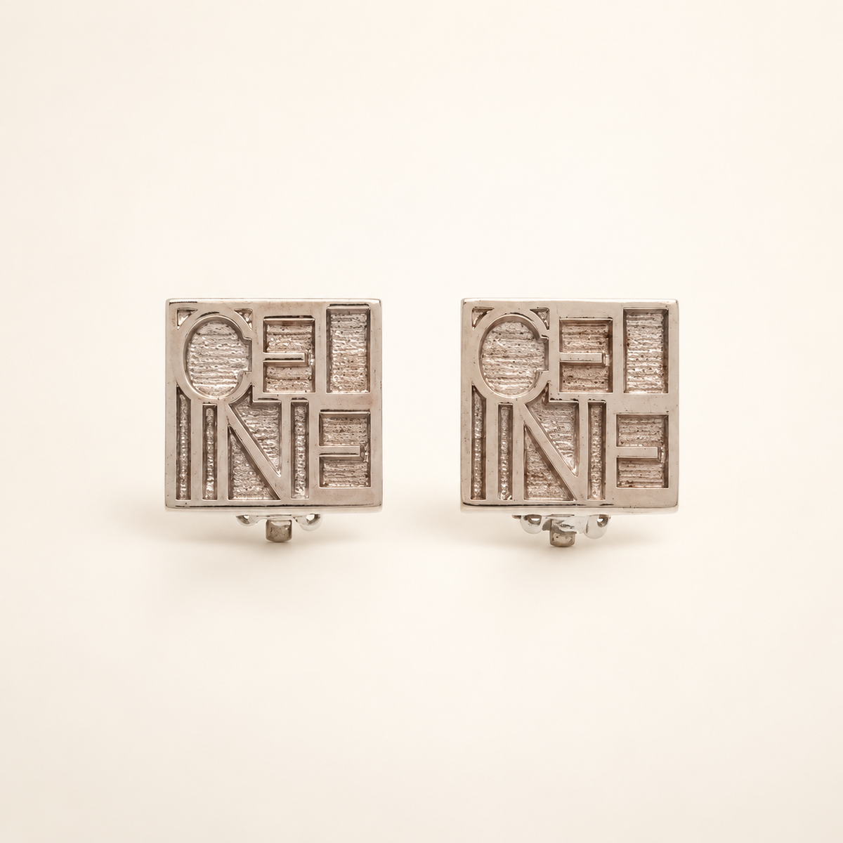 Celine Silver-Tone Square Logo Clip-On Earrings — front view on an ivory background