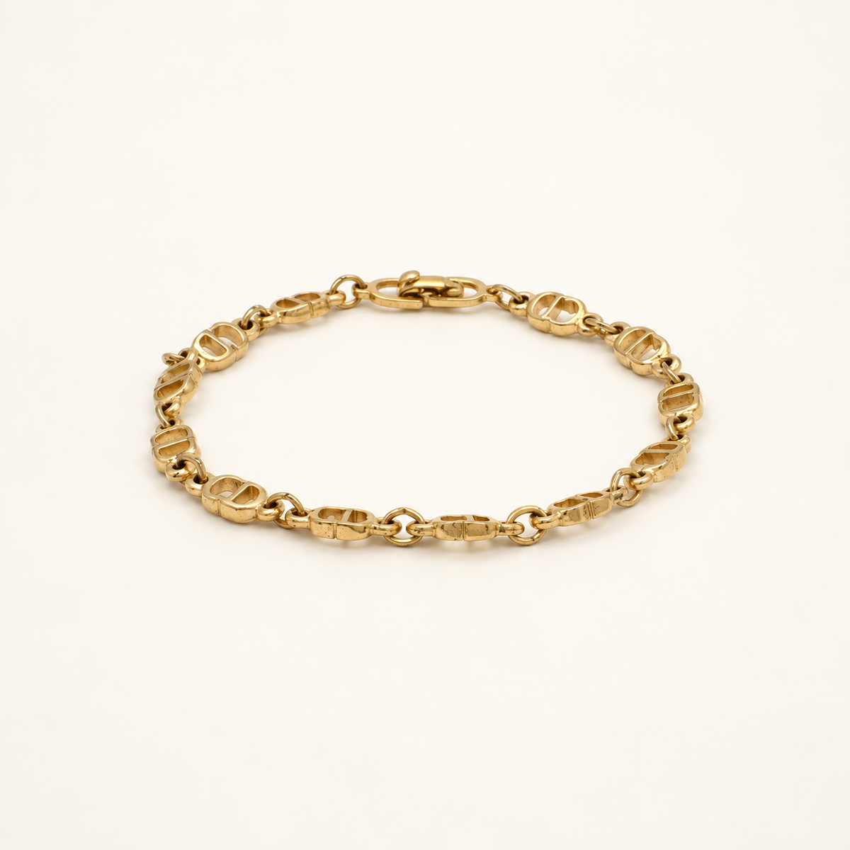Christian Dior Gold-Tone Fine Link Bracelet, 18.5cm — front view on an ivory background