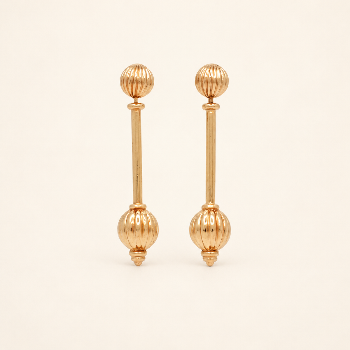 Christian Dior Gold-Tone Long Bar Drop Earrings — front view on an ivory background