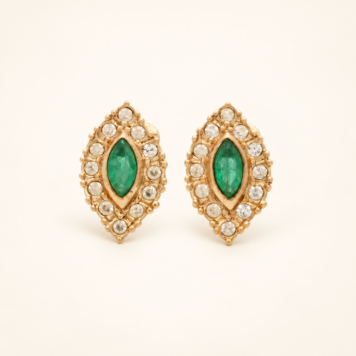 Christian Dior Gold-Tone Green Stone Halo Clip-On Earrings — front view on an ivory background