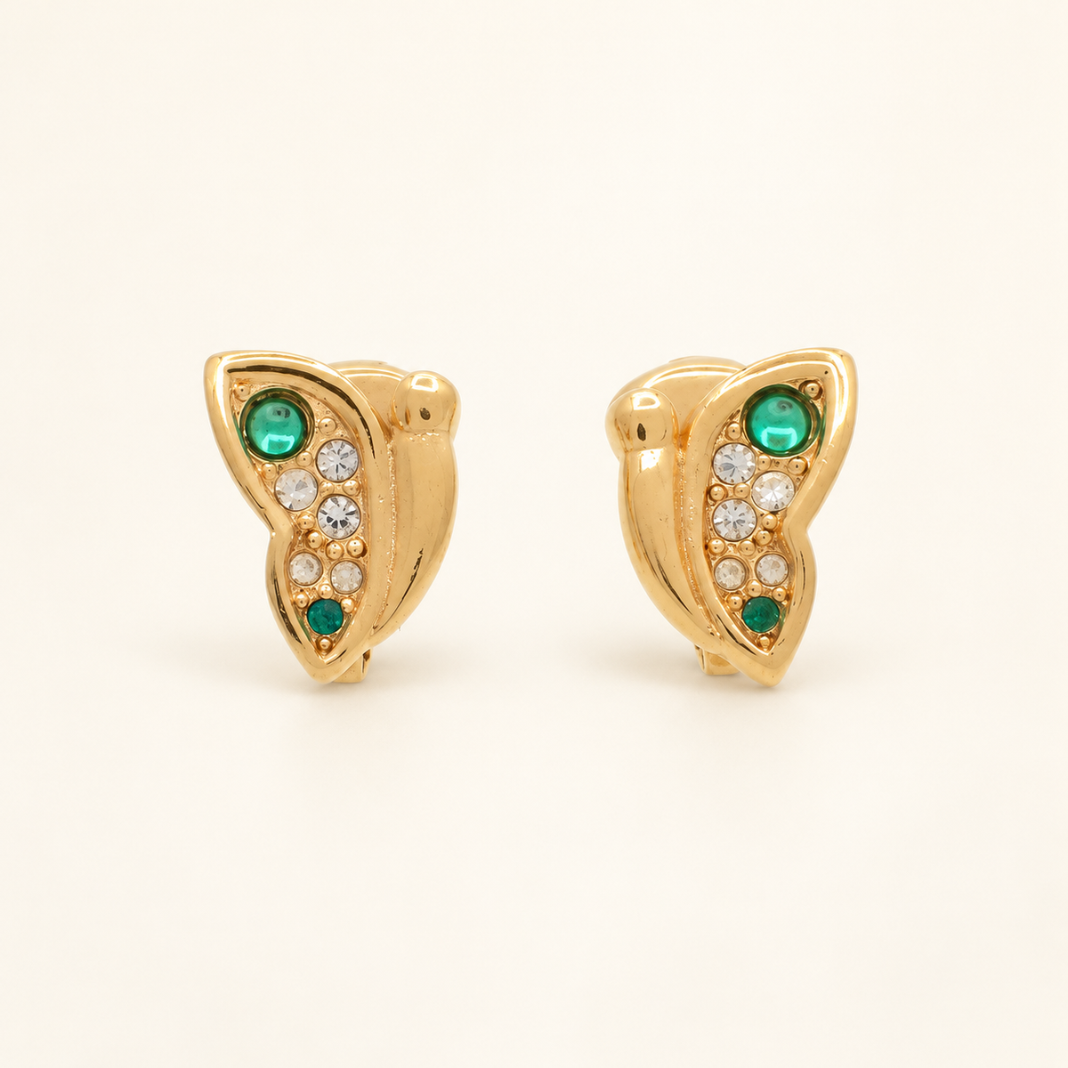 Christian Dior Gold-Tone Green Stone Wing Clip-On Earrings — front view on an ivory background