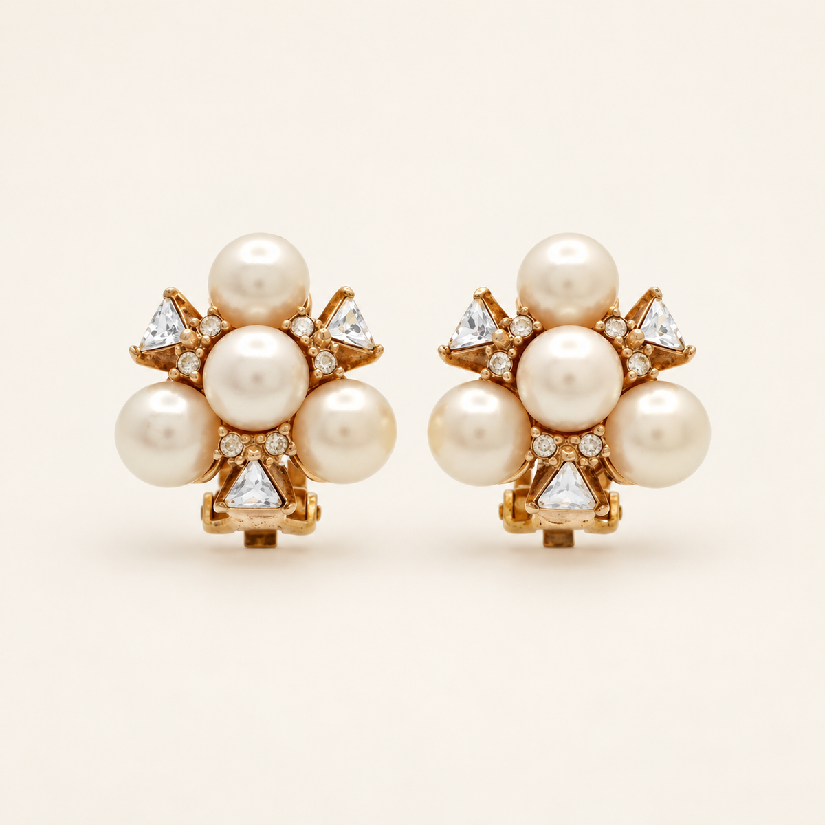 Christian Dior Gold-Tone Faux Pearl Flower Clip-On Earrings — front view on an ivory background