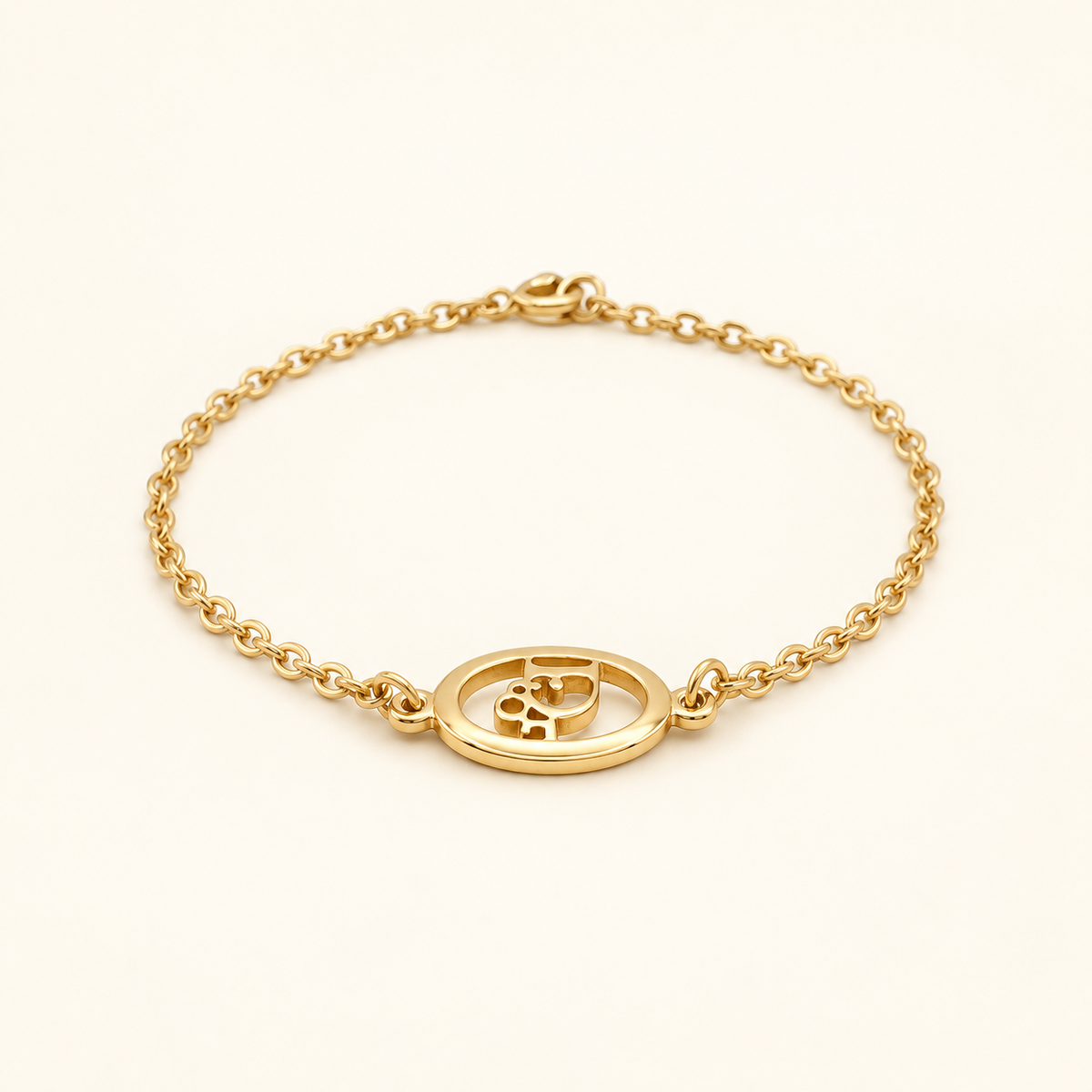 Christian Dior Gold-Tone Oval CD Chain Bracelet — front view on an ivory background