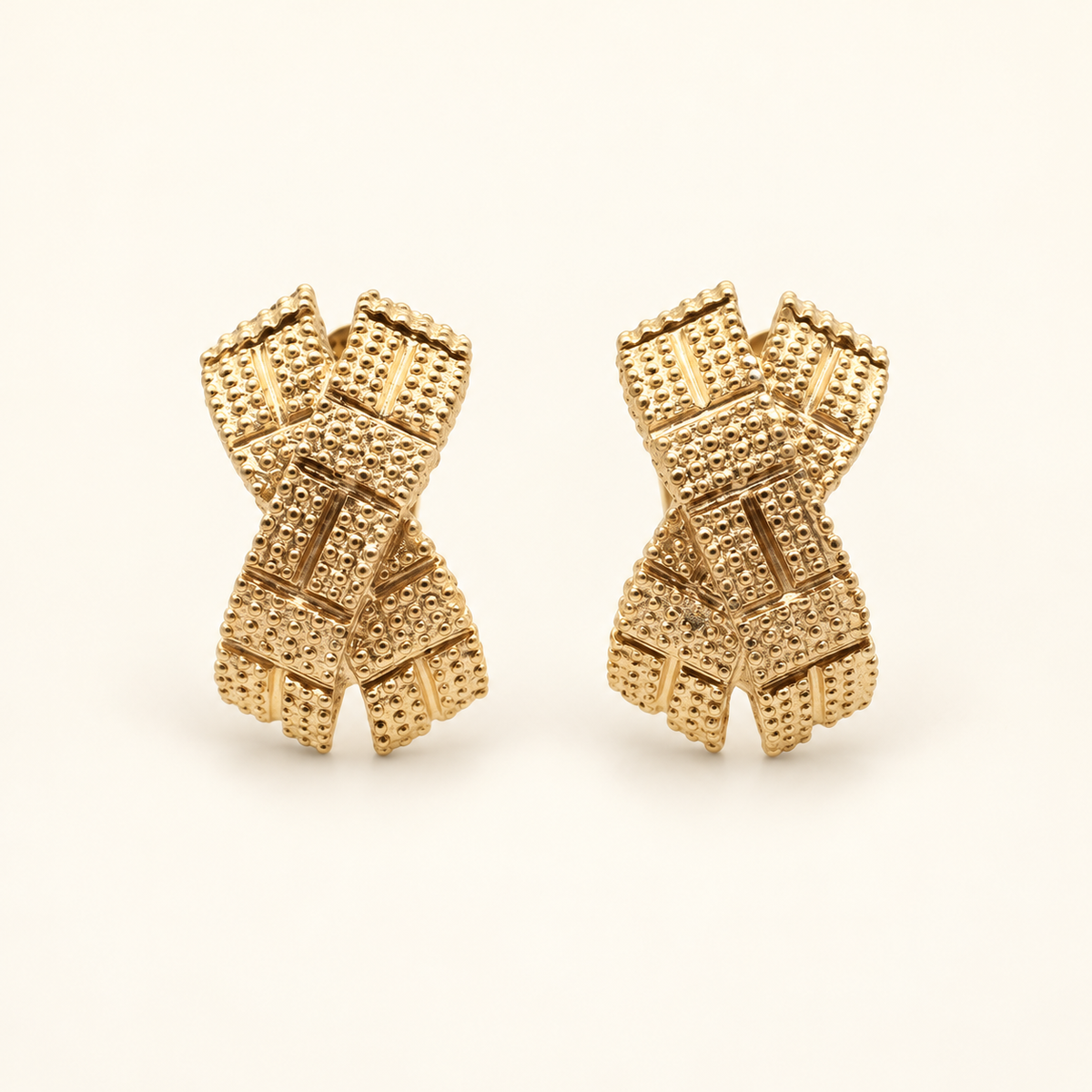 Christian Dior Gold-Tone Textured Bow Clip-On Earrings — front view on an ivory background