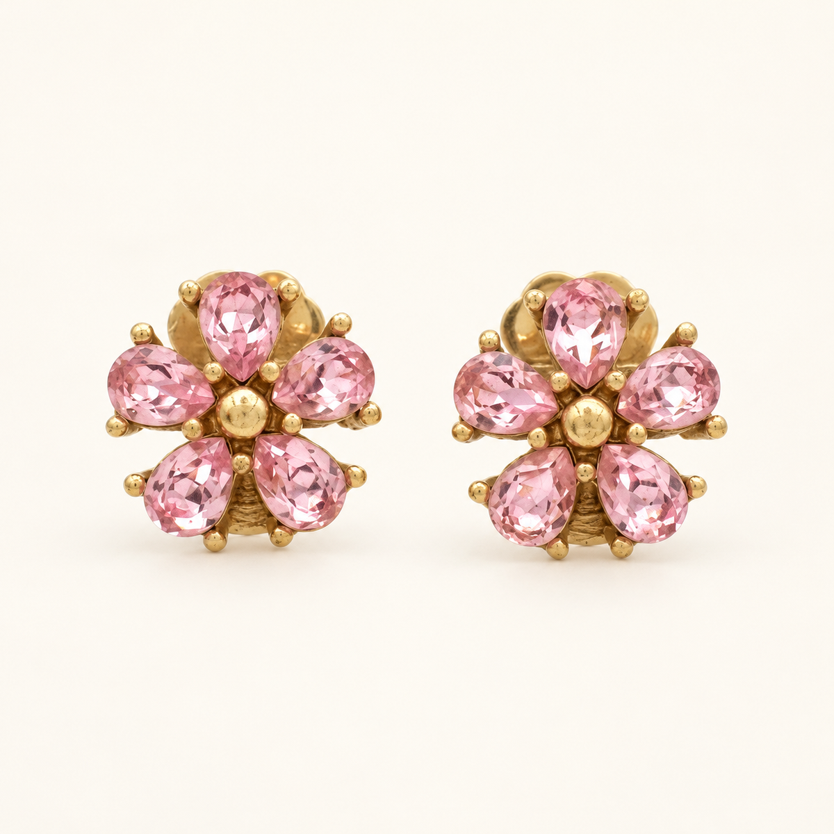 Christian Dior Gold-Tone Pink Stone Flower Clip-On Earrings — front view on an ivory background