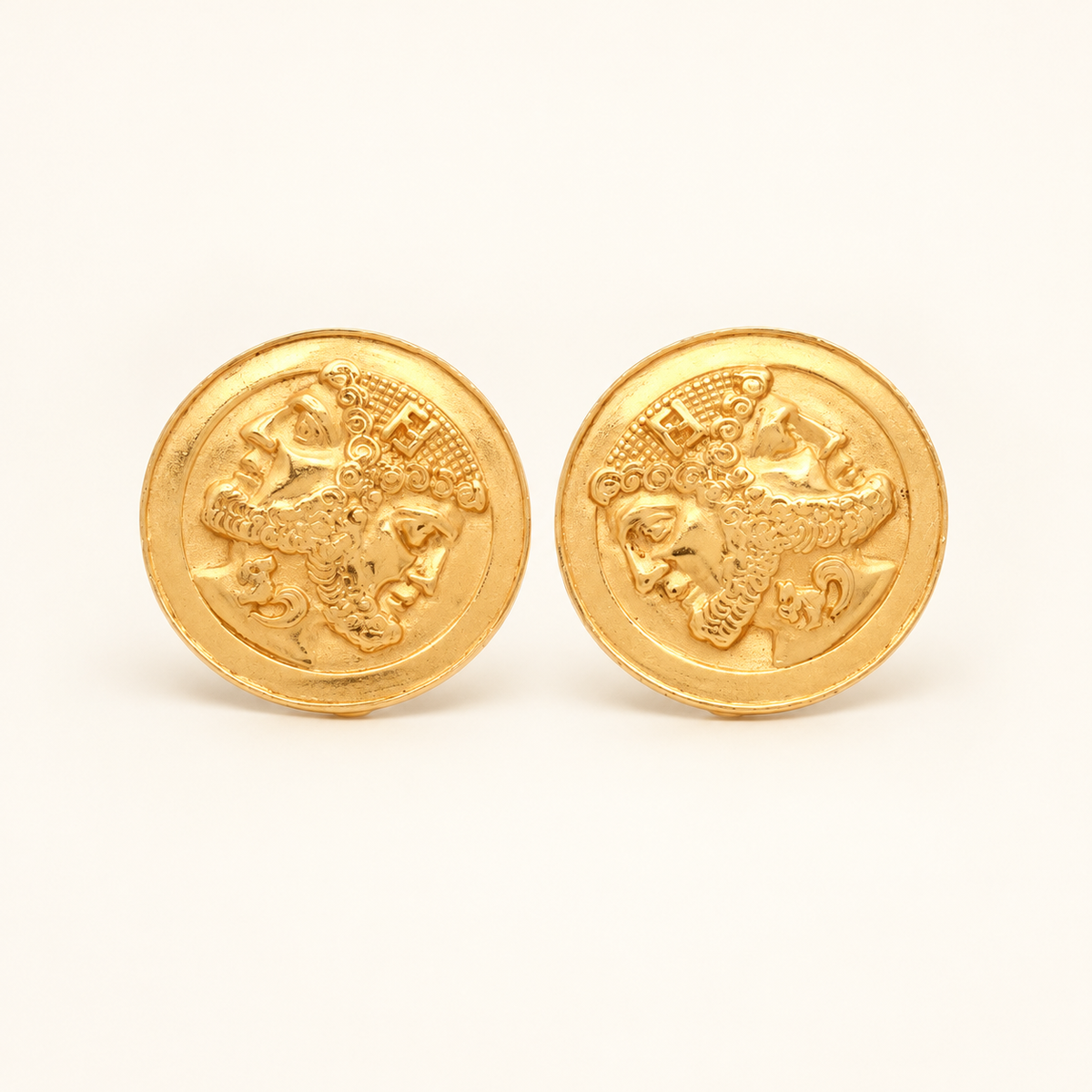 Fendi Gold-Tone Round Medallion Clip-On Earrings — front view on an ivory background