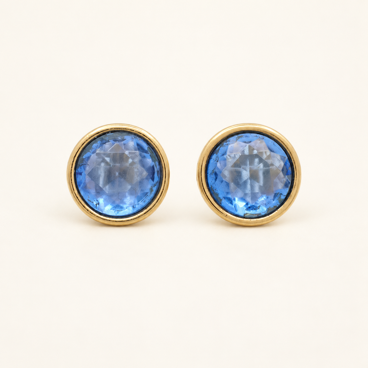 Givenchy Gold-Plated Blue Stone Clip-On Earrings — front view on an ivory background