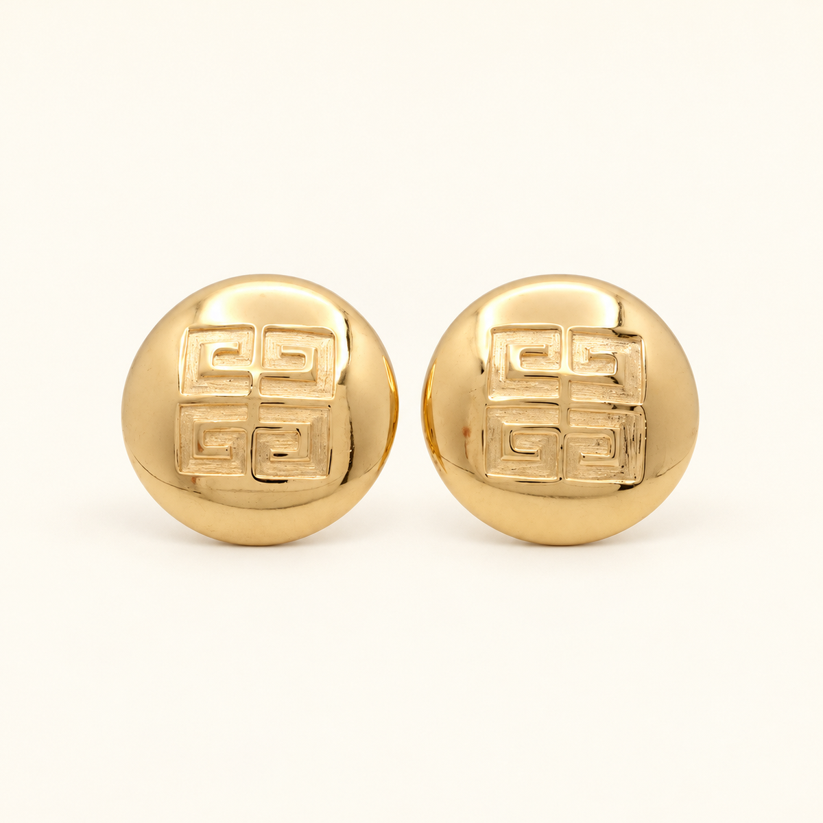 Givenchy Gold-Tone Round 4G Logo Clip-On Earrings — front view on an ivory background
