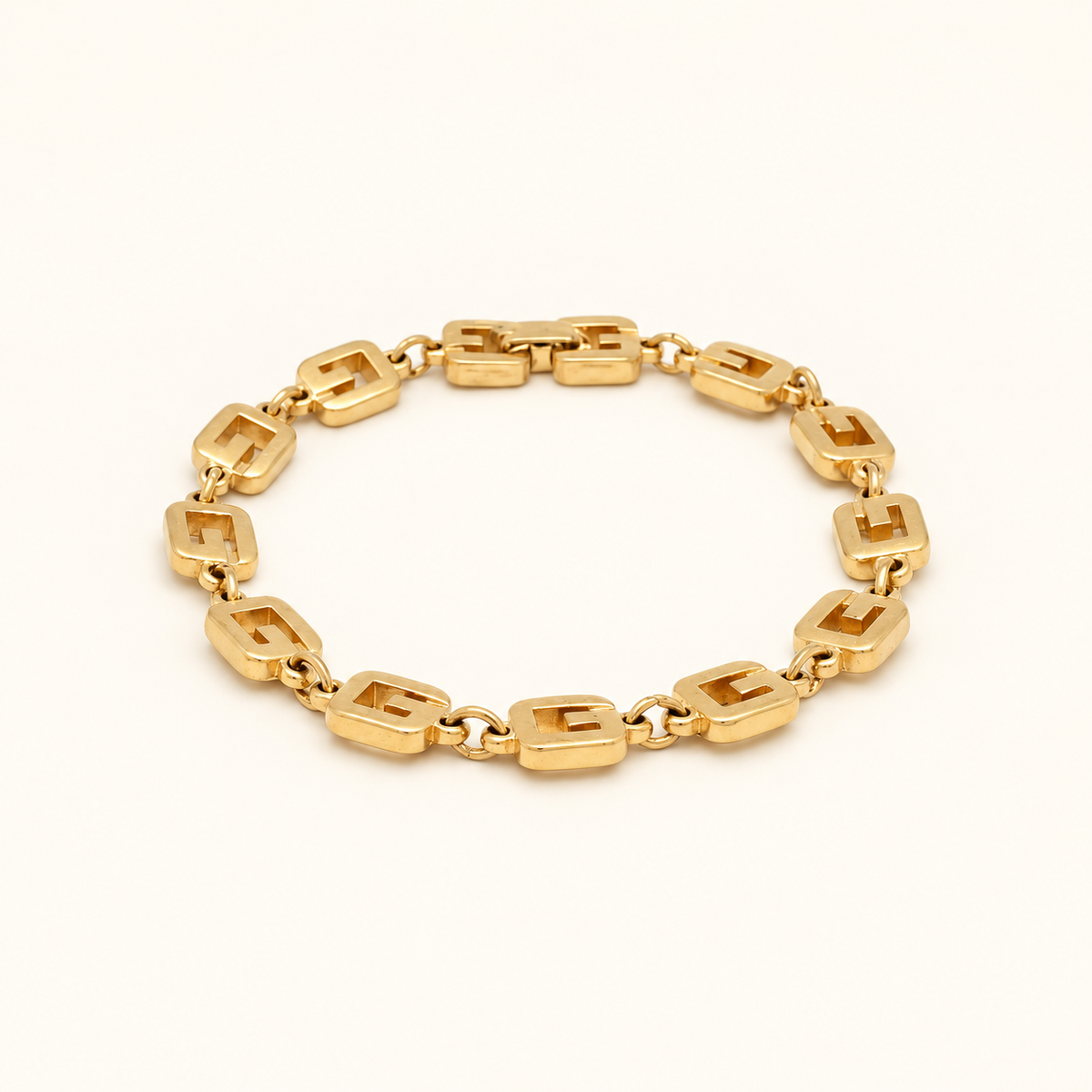 Givenchy Gold-Tone Geometric Link Bracelet — front view on an ivory background