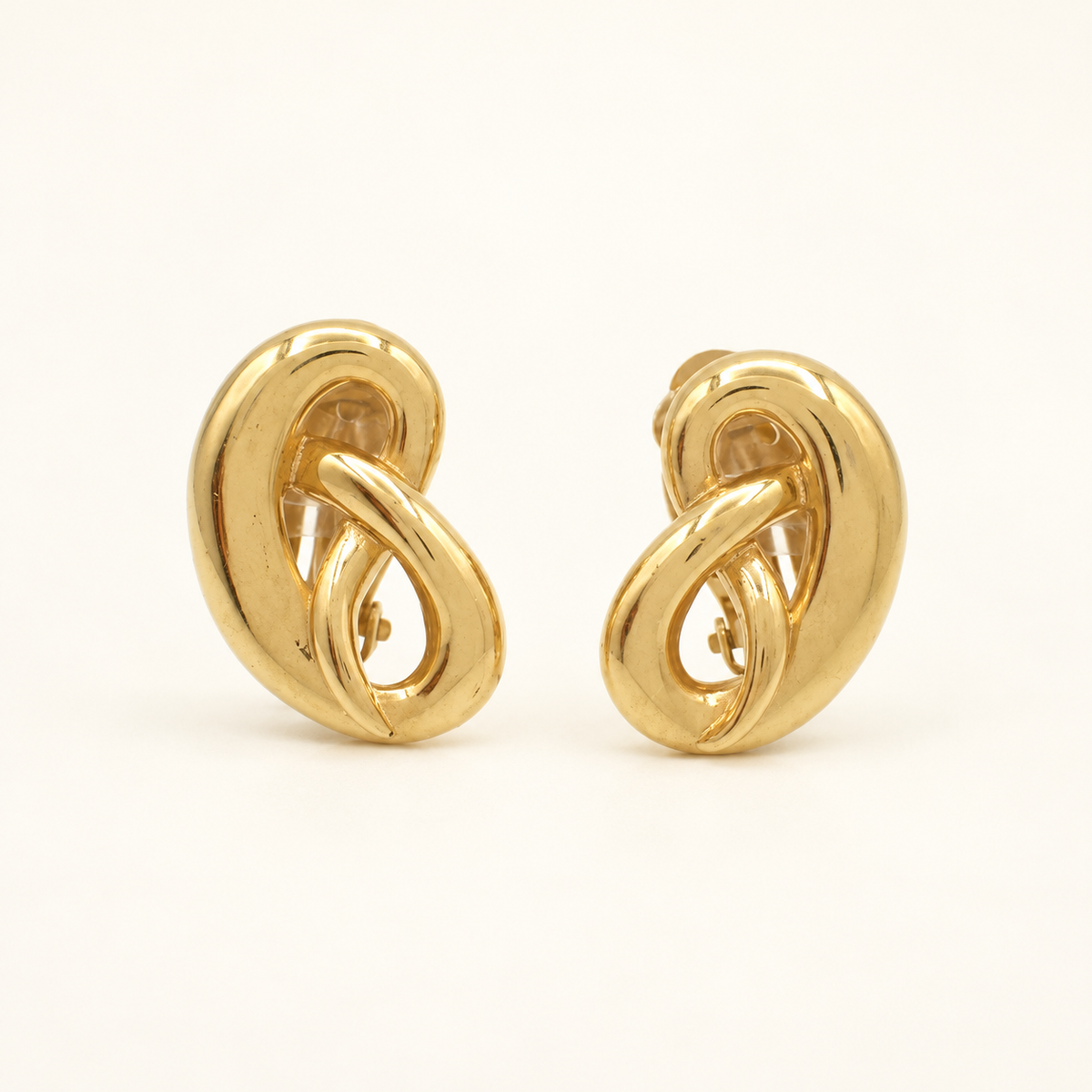 Givenchy Gold-Tone Open Loop Clip-On Earrings — front view on an ivory background