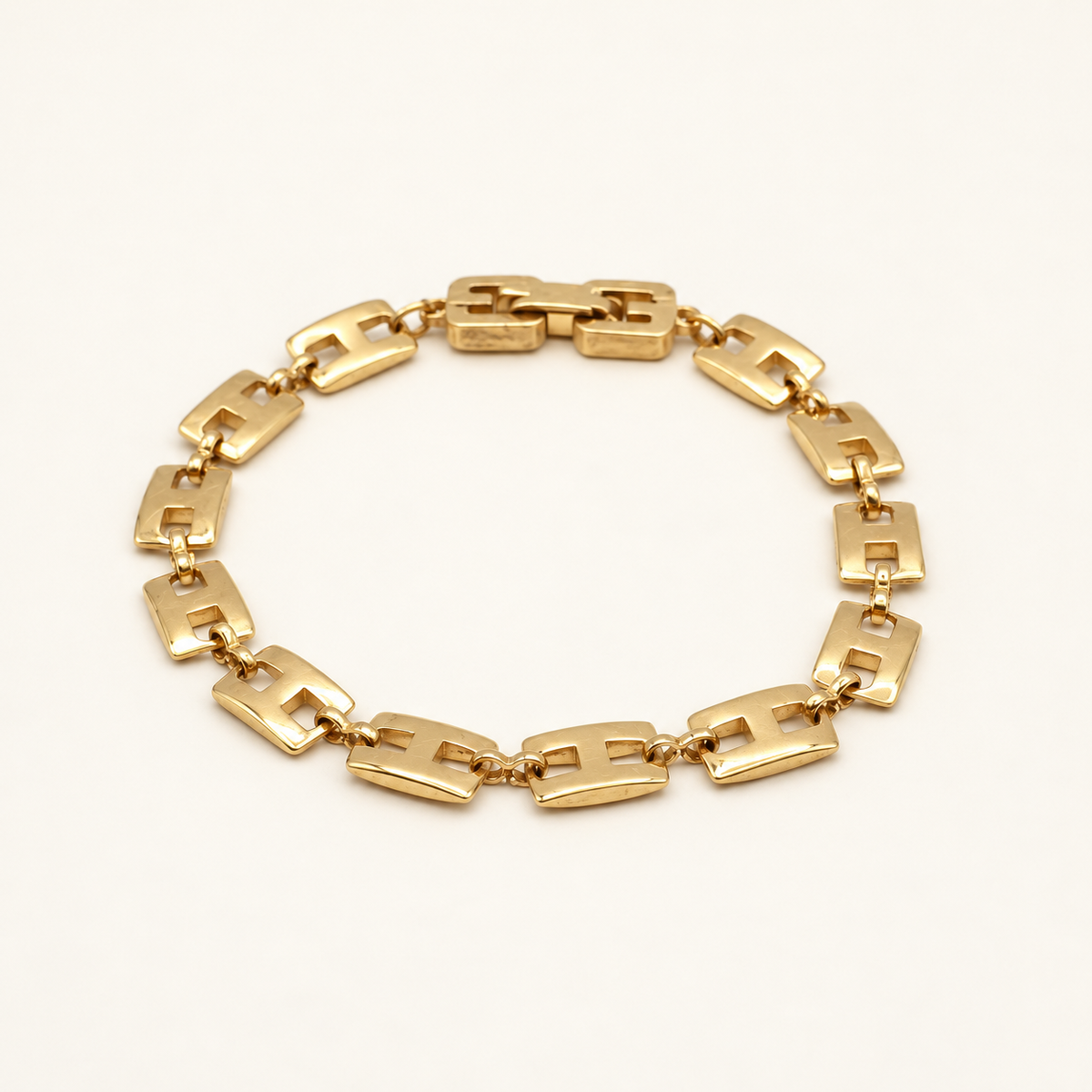 Givenchy Gold-Tone Rectangular Link Bracelet — front view on an ivory background