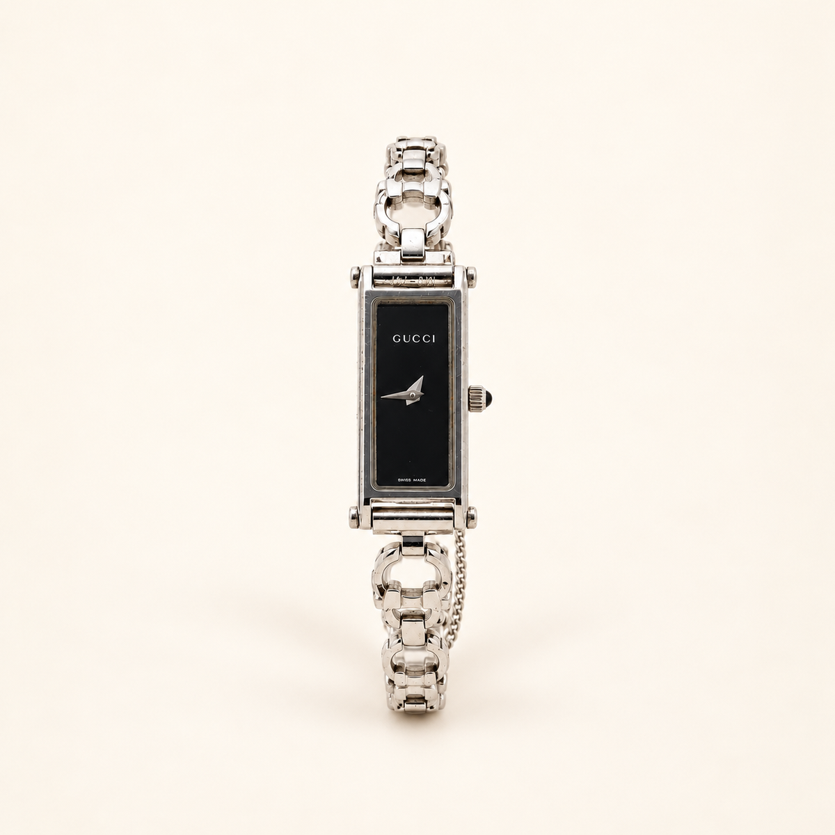 Gucci 1500L Black Dial Silver-Tone Quartz Watch — front view on an ivory background