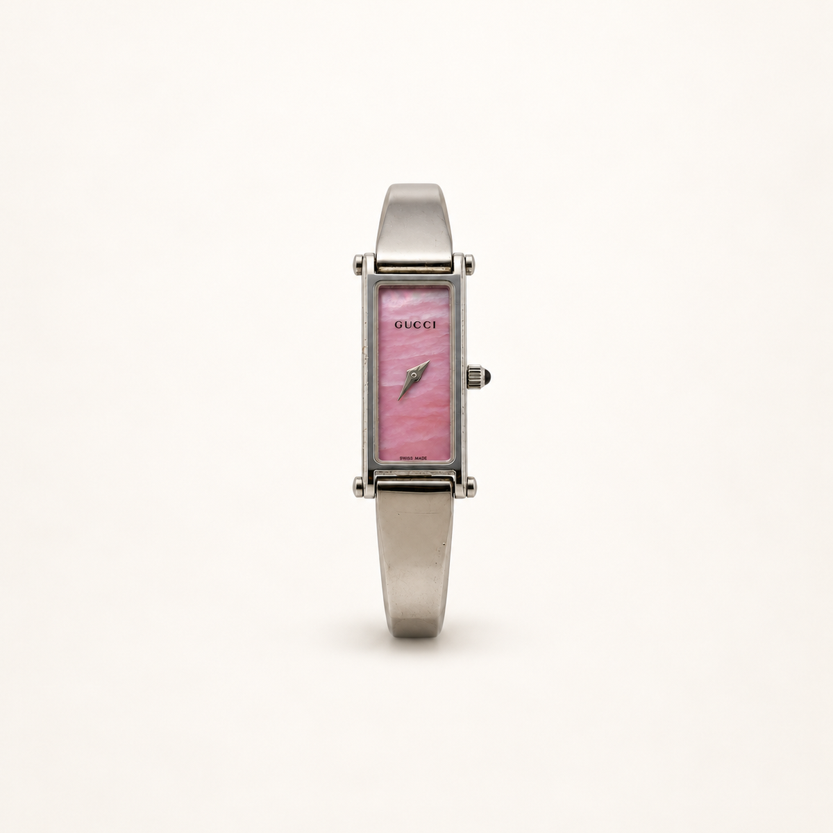 Gucci 1500L Pink Dial Silver-Tone Quartz Bangle Watch — front view on an ivory background