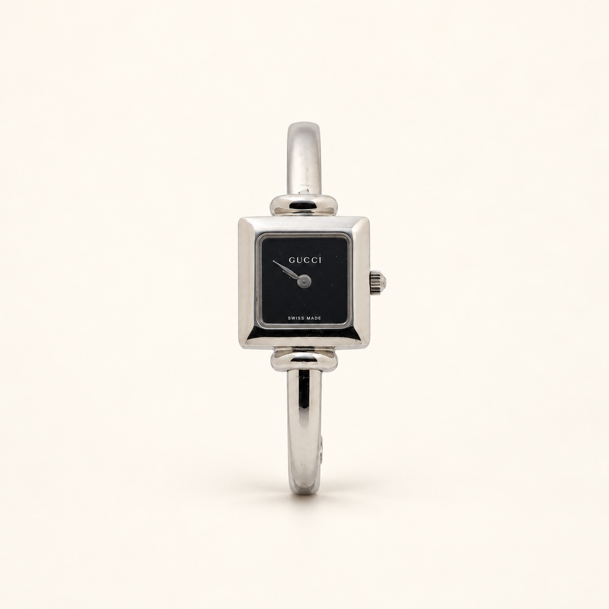 Gucci 1900L Black Dial Square Quartz Bangle Watch — front view on an ivory background
