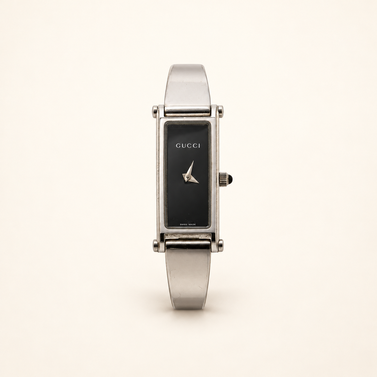 Gucci 1500L Black Dial Quartz Bangle Watch — front view on an ivory background
