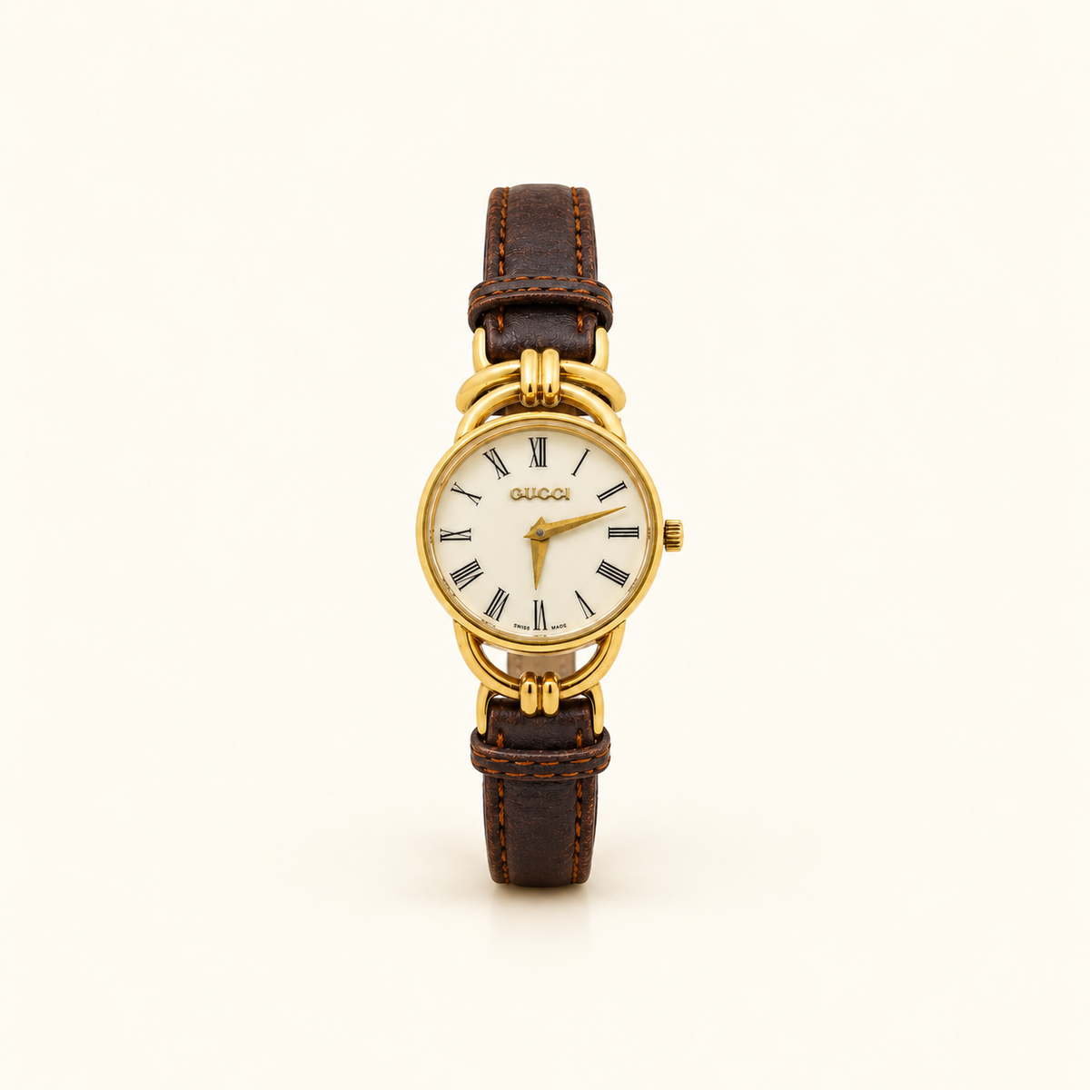 Gucci Gold-Tone White Roman Dial Quartz Watch — front view on an ivory background