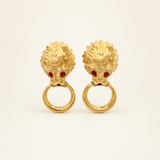 Nina Ricci Gold-Tone Lion Head Ring Drop Clip-On Earrings — front view on an ivory background