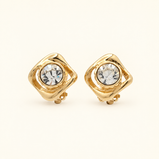 Yves Saint Laurent Gold-Plated Clear Stone Clip-On Earrings — front view on an ivory background