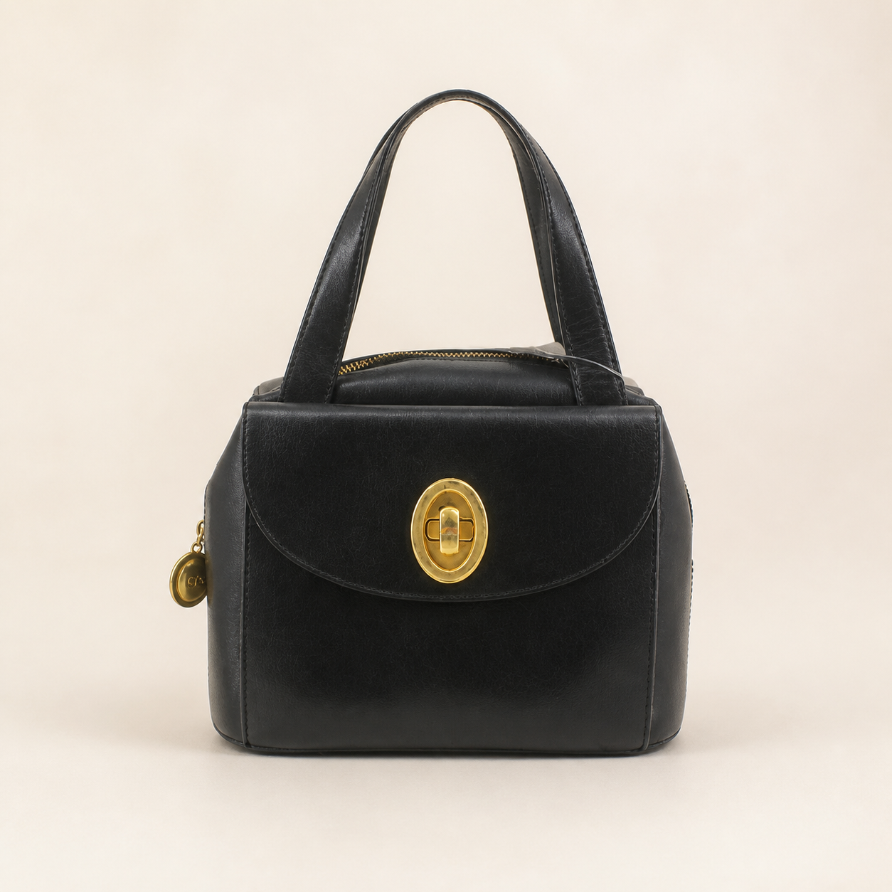 Christian Dior vintage black leather box handbag with oval gold-tone turn-lock, front view